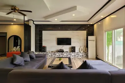 a living room with a couch and a flat screen tv at Jewelry Resort and Villas Tagaytay in Silang