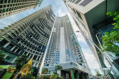 a tall building in a city with tall buildings at StayHere 3BR Penthouse Knightsbridge Makati in Manila