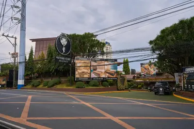 a parking lot with a sign on the side of a street at Victoria Court Hillcrest in Manila