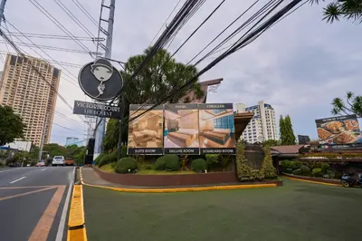a street with signs on the side of a road at Victoria Court Hillcrest in Manila