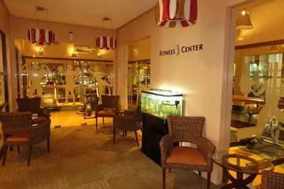 a store with a fish tank in a room with chairs at Luxury Condo at Forbeswood Parklane The Fort BGC in Manila