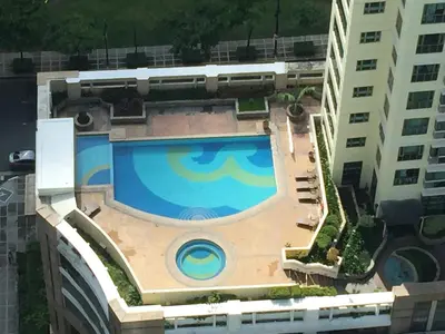 an overhead view of a swimming pool next to a building at Luxury Condo at Forbeswood Parklane The Fort BGC in Manila