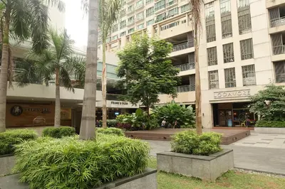 a building with trees and bushes in front of it at Luxury Condo at Forbeswood Parklane The Fort BGC in Manila