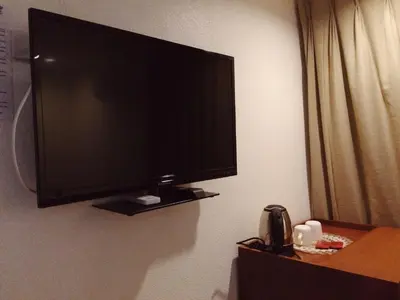 a flat screen tv on a wall in a hotel room at Chinatown Lai Lai Hotel Inc in Manila