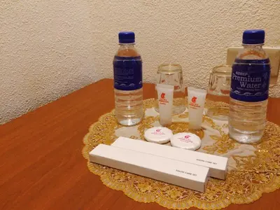 two bottles of water and two glasses on a table at Chinatown Lai Lai Hotel Inc in Manila