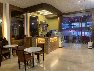 a restaurant with tables and chairs and a bar at Chinatown Lai Lai Hotel Inc in Manila