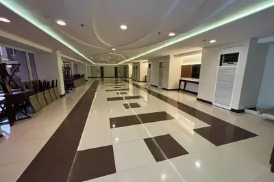 a large hallway with a black and white tile floor at Extremeli Suites in Manila
