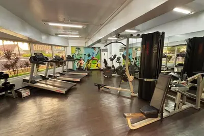 a gym with a bunch of treadms and machines at Extremeli Suites in Manila