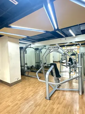 a gym with treadmills and ellipticals at Exquisite Japandi at Venice with Grand Canal view in Manila
