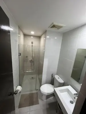 a bathroom with a shower and a toilet and a sink at Wanderlust Haven in Manila