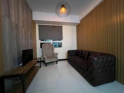 a living room with a couch and a chair at Wanderlust Haven in Manila
