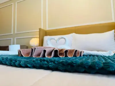 a bed with blankets and pillows on it at Venice Staycation Cozy Glimpse of Grand Canal View Retreat in Manila