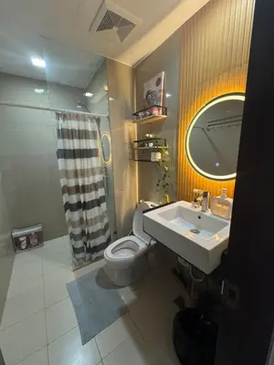 a bathroom with a sink and a toilet and a mirror at Venice Staycation Cozy Glimpse of Grand Canal View Retreat in Manila