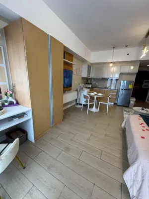 a kitchen and living room with a couch and a table at Venice Staycation Cozy Glimpse of Grand Canal View Retreat in Manila