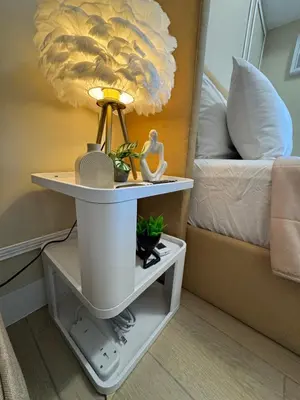a table with a lamp on it next to a bed at Venice Staycation Cozy Glimpse of Grand Canal View Retreat in Manila