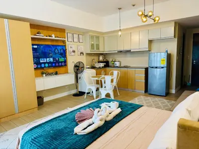 a kitchen with a table with towels on it at Venice Staycation Cozy Glimpse of Grand Canal View Retreat in Manila