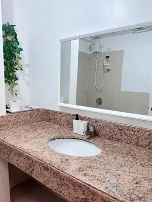 a bathroom counter with a sink and a mirror at Near NAIA 3 Condo in Manila