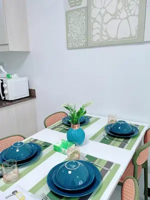 a dining room table with blue dishes on it at Near NAIA 3 Condo in Manila