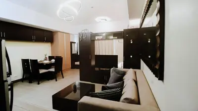 a living room with a couch and a dining room at Venice Stay! Free Amenities, Steps to Grand Canal in Manila