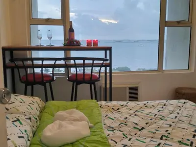 a living room with a table and chairs and a couch at Chic Haven in Manila