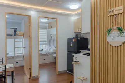 a kitchen with a door open to a room at Family Friendly Stay UrbanDeca in Manila