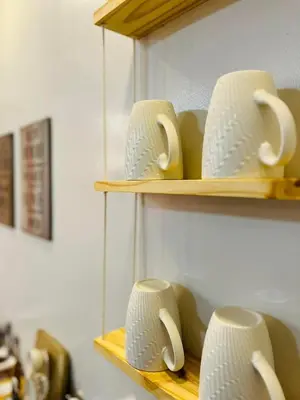 a bunch of cups sitting on shelves at Fablo Staycation By Enchanted Kingdom in Santa Rosa