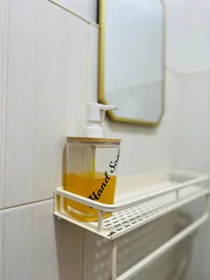 a bottle of oil sitting on a shelf in a bathroom at Fablo Staycation By Enchanted Kingdom in Santa Rosa