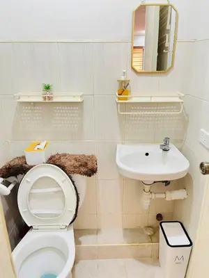 a bathroom with a toilet and a sink at Fablo Staycation By Enchanted Kingdom in Santa Rosa