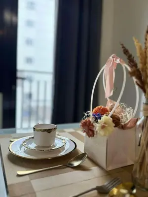 a table with a cup and a plate with a tea set at Cassa Bella in Manila