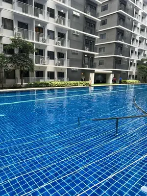 a large swimming pool in front of a building at Cassa Bella in Manila