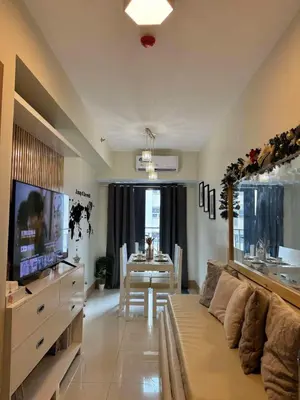 a living room with a couch and a dining room at Cassa Bella in Manila