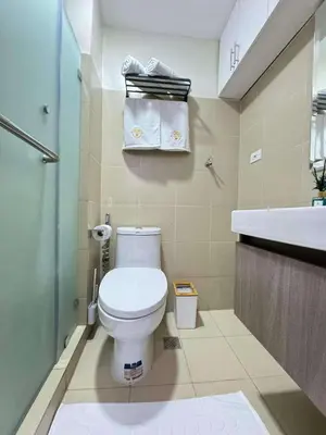 a small bathroom with a toilet and a sink at Cassa Bella in Manila
