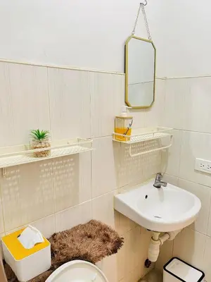 a bathroom with a sink and a toilet and a mirror at Fablo Getaway Staycation Beside Enchanted Kingdom in Santa Rosa