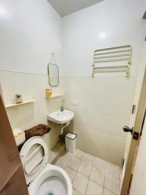 a bathroom with a toilet and a sink at Fablo Getaway Staycation Beside Enchanted Kingdom in Santa Rosa
