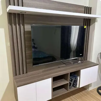 a flat screen tv sitting on top of a entertainment center at Tulip Garden Apricot Bldg 1BR with pool and Gym in Biñan