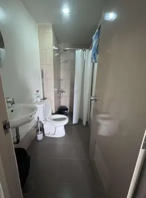 a small bathroom with a toilet and a sink at Tulip Garden Apricot Bldg 1BR with pool and Gym in Biñan