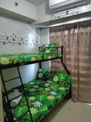 a bedroom with two bunk beds in a room at My Place in Manila