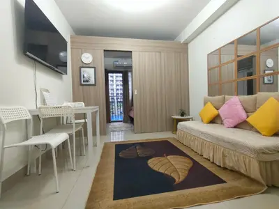 a living room with a couch and a table at Sweet Staycation in Manila