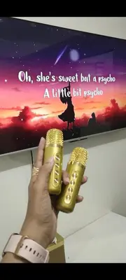 a person holding a wii remote in front of a tv at Sweet Staycation in Manila