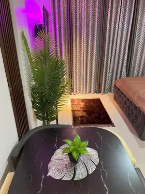 a table with a potted plant on top of it at Modern Studio near LRT, MOA & Star City in Pasay in Manila