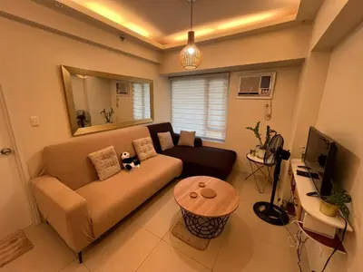 a living room with a couch and a table at Rolly's Place in Manila