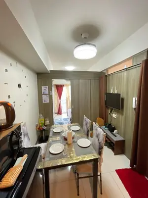 a dining room with a table and chairs at LJ's escape 2BR COAST Residences in Manila