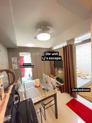 a living room with a table and a couch at LJ's escape 2BR COAST Residences in Manila