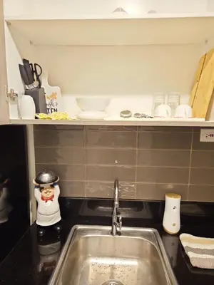 a kitchen counter with a sink in a kitchen at Condo next door in Manila