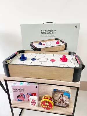 two trays of toys on a cart with a table at 212 Budget Condo at Shore 3 The Dwelling place in Manila