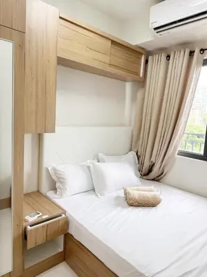 a bed in a small room with a window at 212 Budget Condo at Shore 3 The Dwelling place in Manila