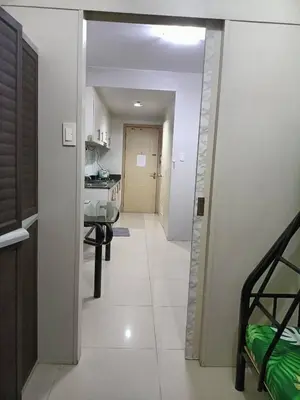 a hallway leading to a room with a kitchen at Roiden Sea Residences in Manila