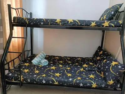 a black bunk bed with a pillow on it at Roiden Sea Residences in Manila