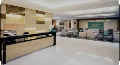 a large lobby with couches and chairs in a building at Staycation at a Breeze 01 in Manila