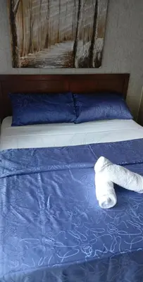 a white object is laying on a bed at Staycation at a Breeze 01 in Manila